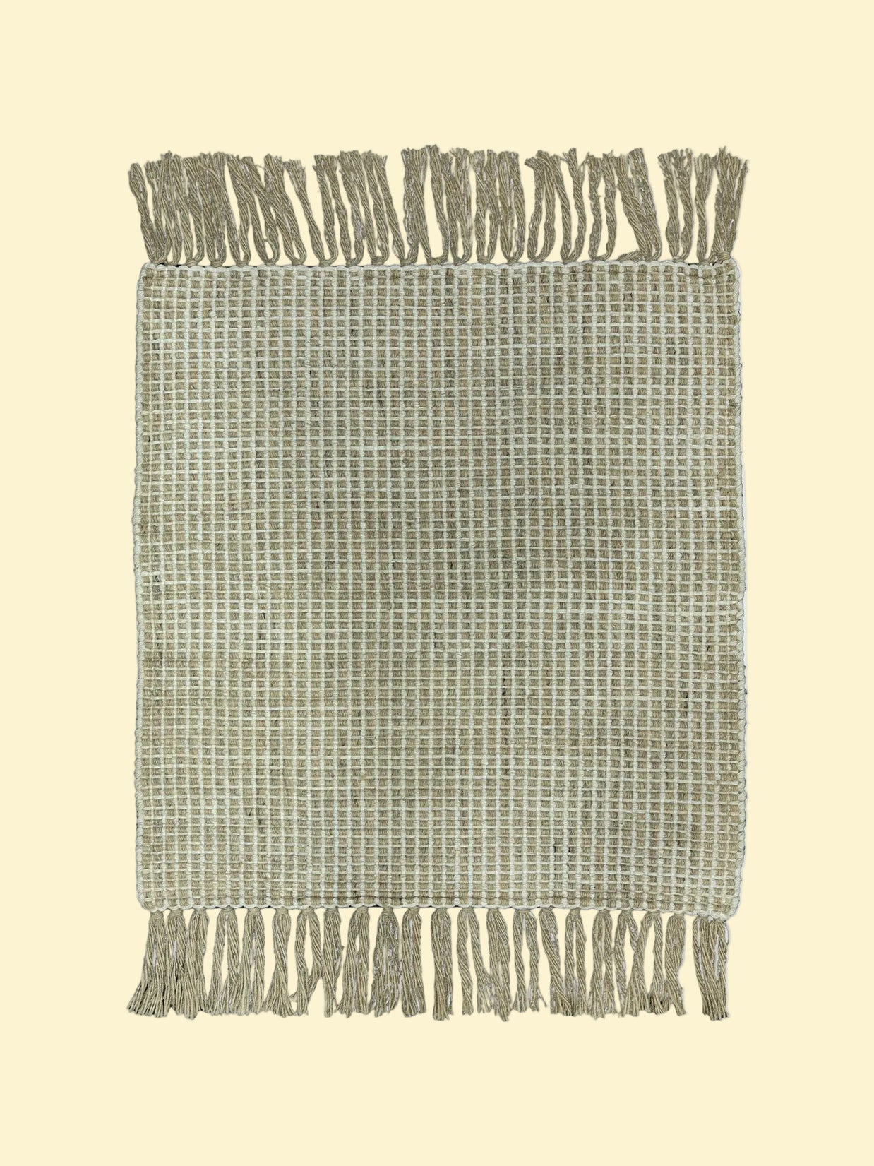 Textured woven blanket with fringe on a white background