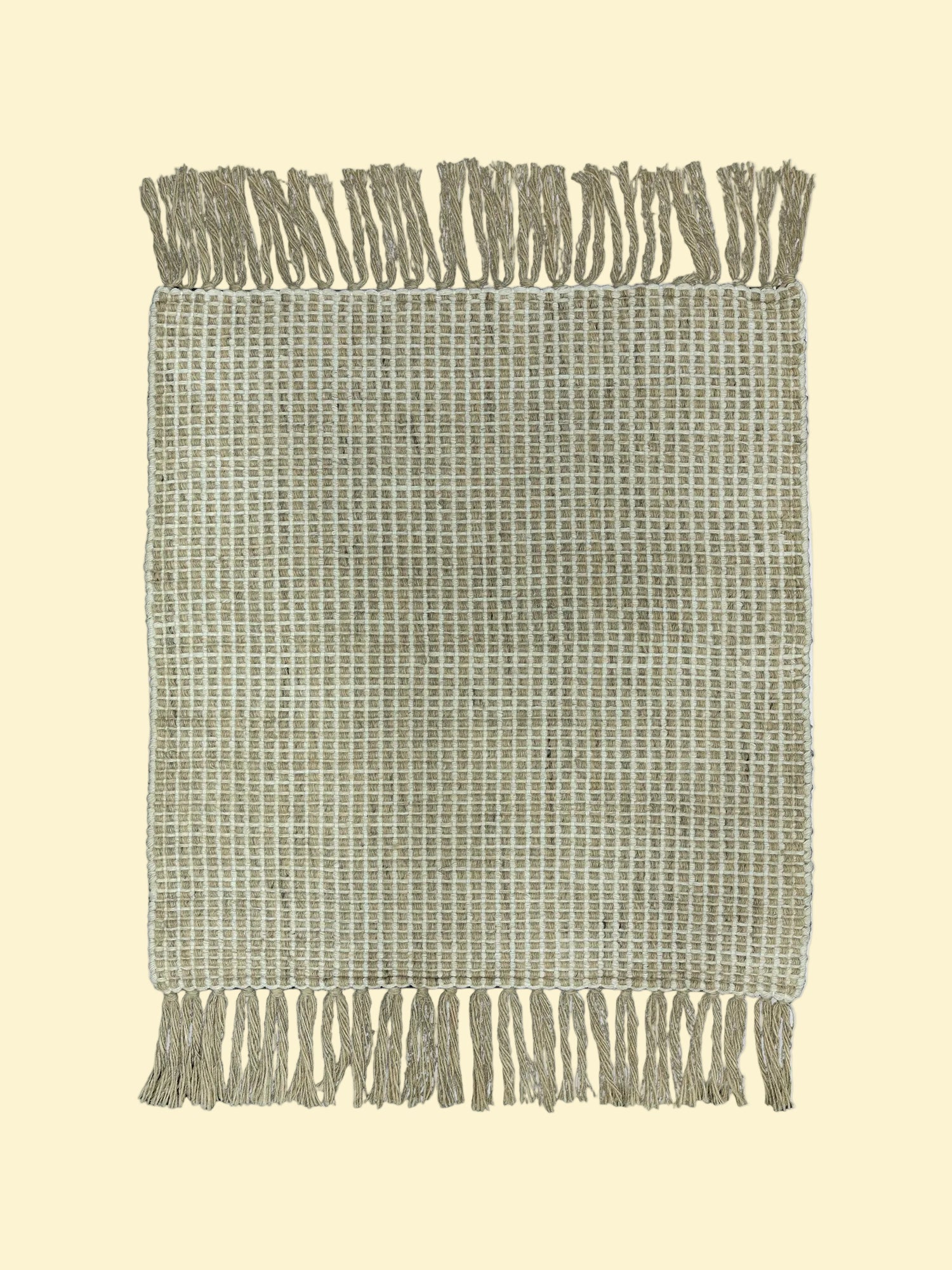 Textured woven blanket with fringe on a white background
