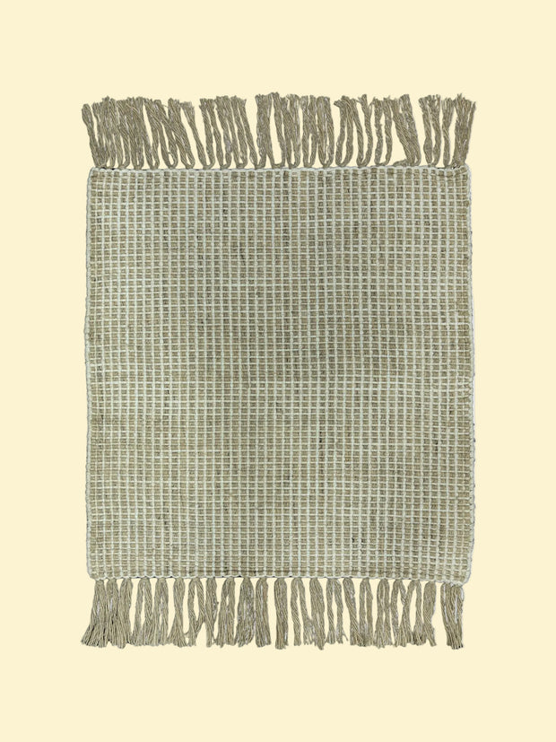 Textured woven blanket with fringe on a white background