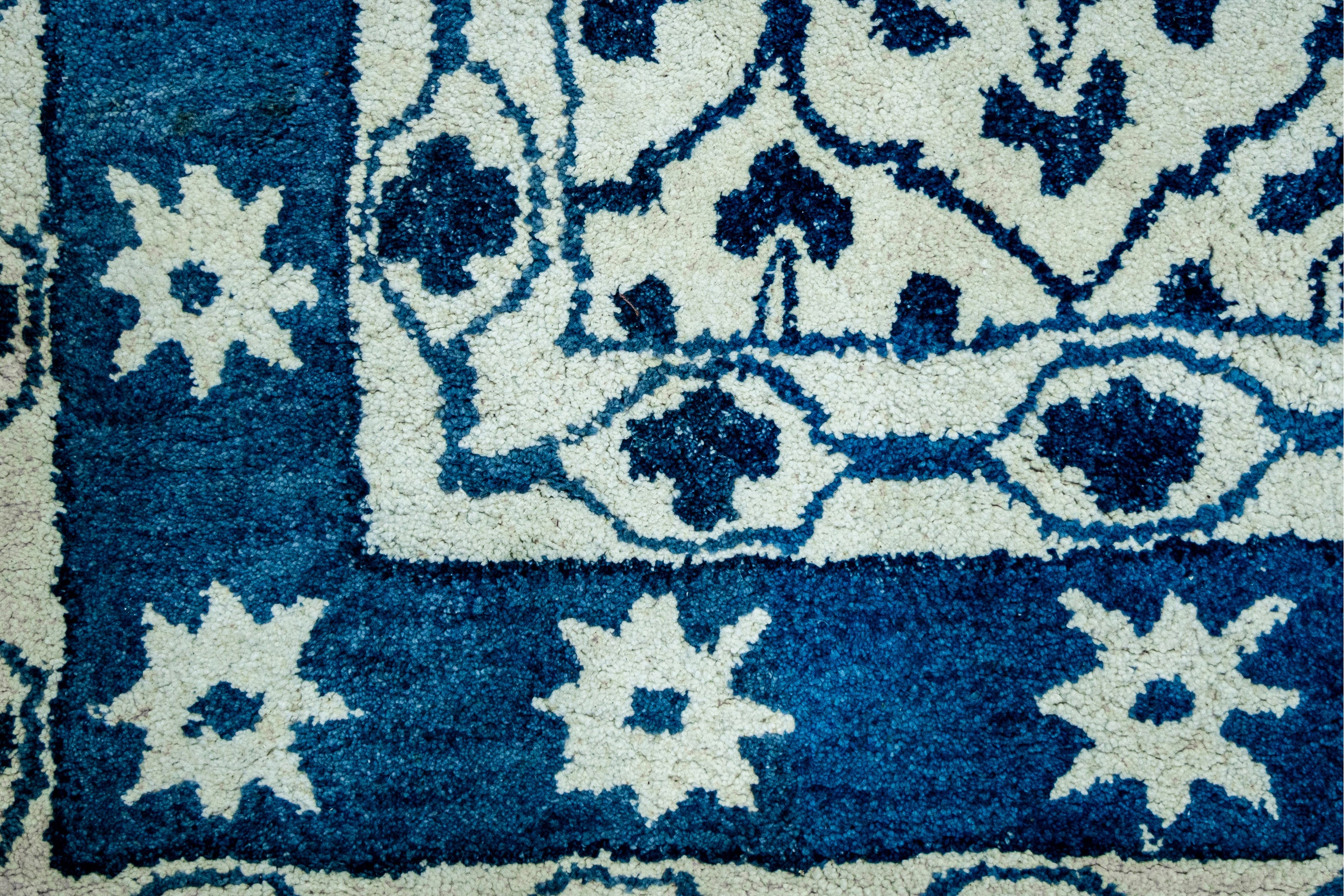 Detail  Shot of Blue and White Patterned Hand-Tufted Woolen Handmade Rug for bed rooms, offices, and dining spaces. 