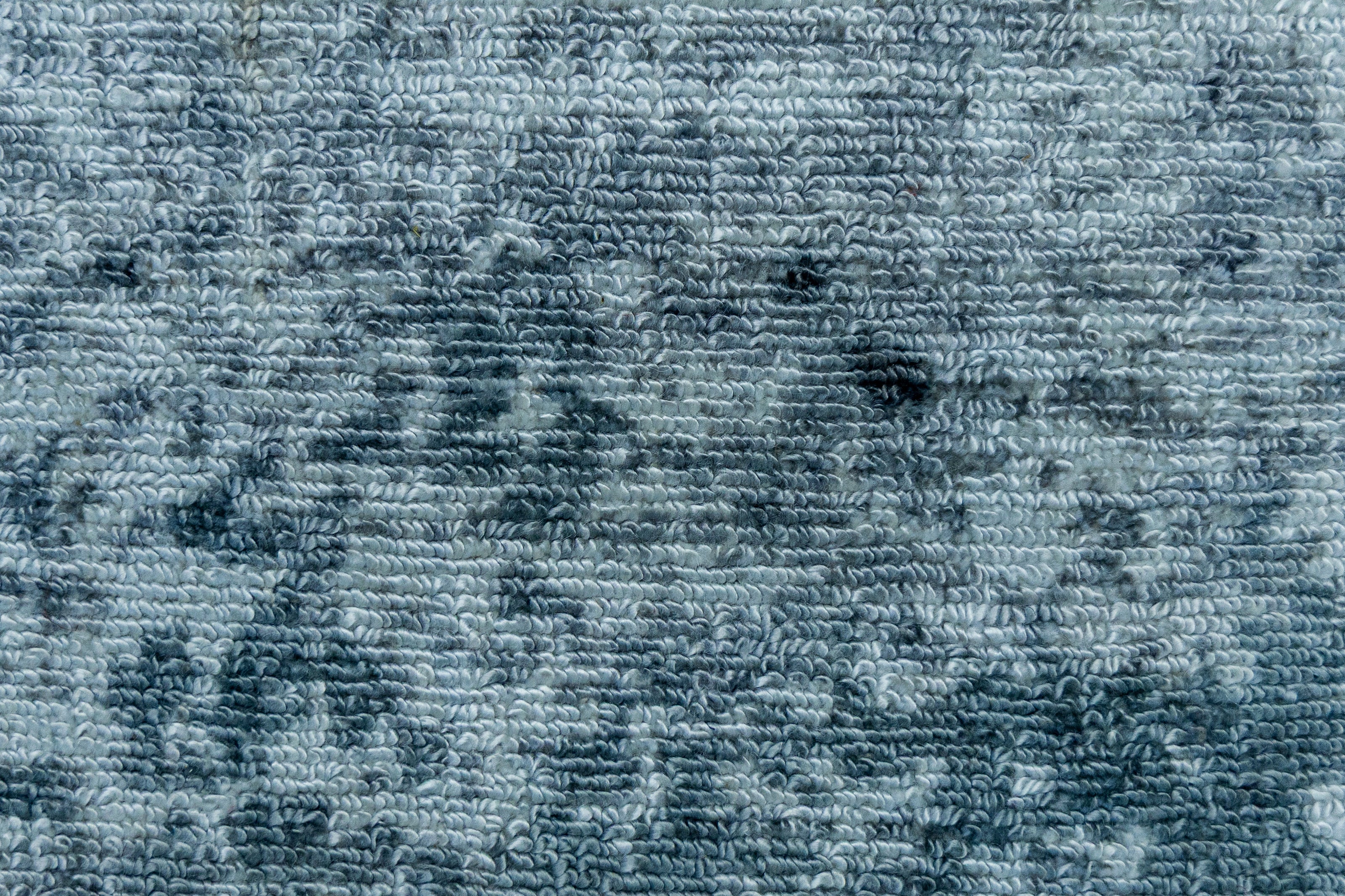 Detail shot of Blue Textured Hand-Loom Printed Viscose Handmade Rug for bed rooms, offices, and dining spaces.