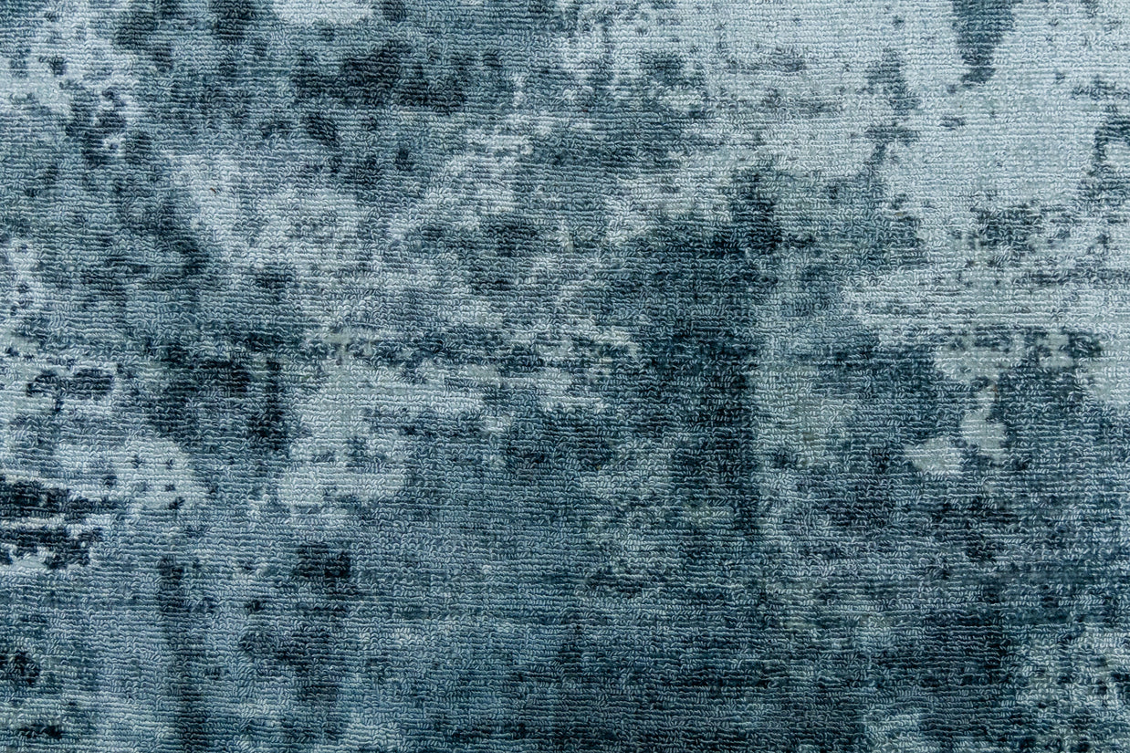 Detail shot of Blue Textured Hand-Loom Printed Viscose Handmade Rug for bed rooms, offices, and dining spaces.