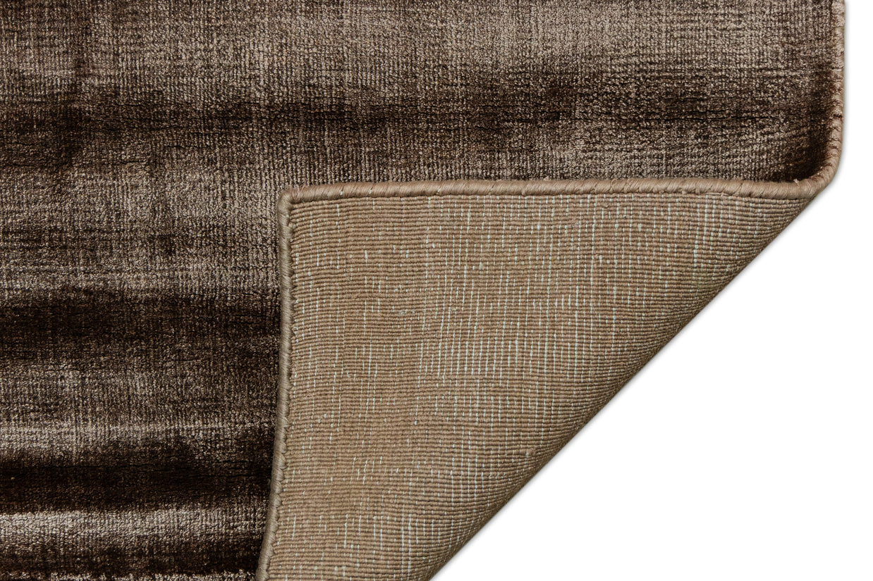Detail Shot of a Textured Brown and Beige Hand-Loom Woolen Handmade Rug for bed rooms, offices, and dining spaces. 