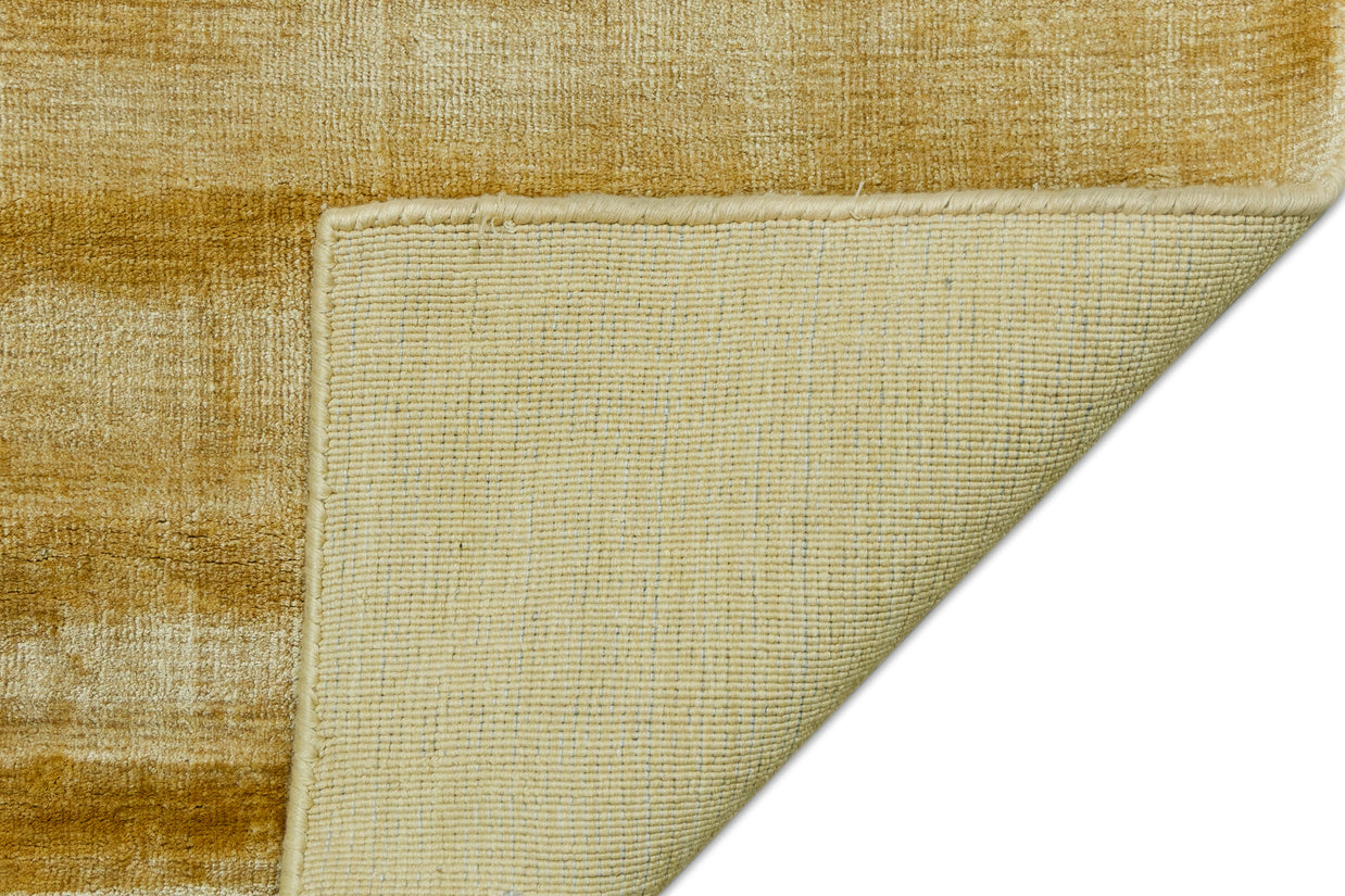Detail Shot of Textured Gold and Beige Hand-Loom Viscose Handmade Rug for Modern bed rooms, offices, and dining spaces.