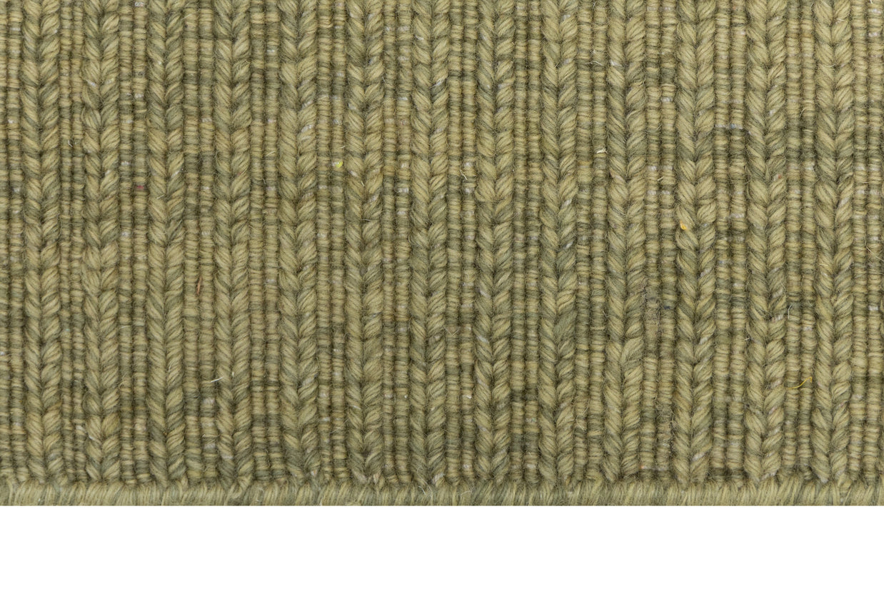 Close-up of Green Texture Hand-Woven Soumak woolen rug for bed rooms, offices, and dining spaces. 