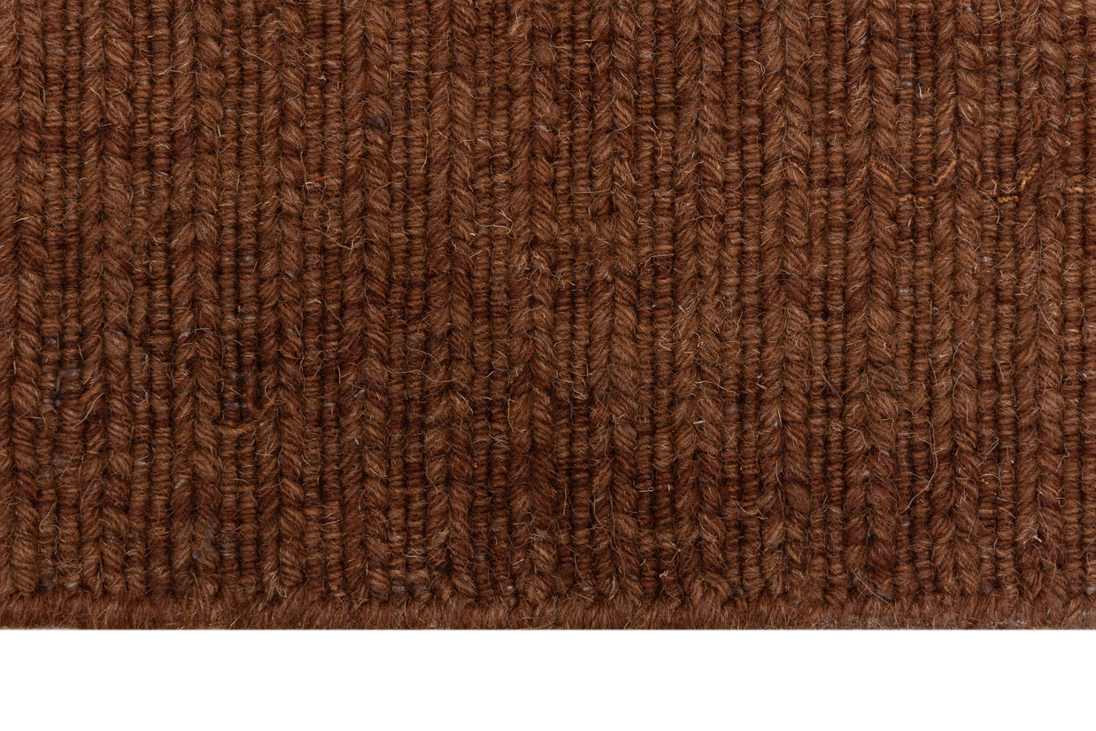 Close-up of Brown Texture Hand-Woven Soumak woolen rug for bed rooms, offices, and dining spaces. 
