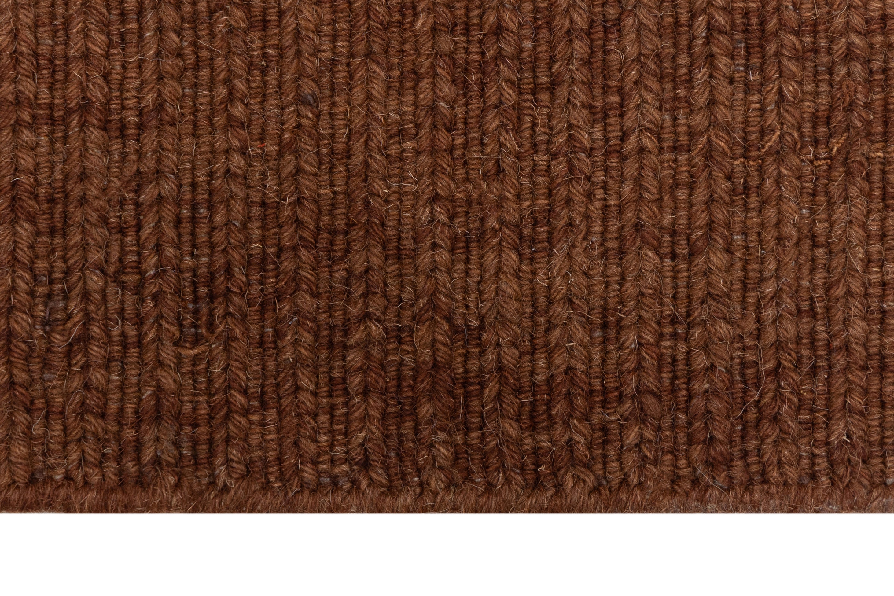 Close-up of Brown Texture Hand-Woven Soumak woolen rug for bed rooms, offices, and dining spaces. 