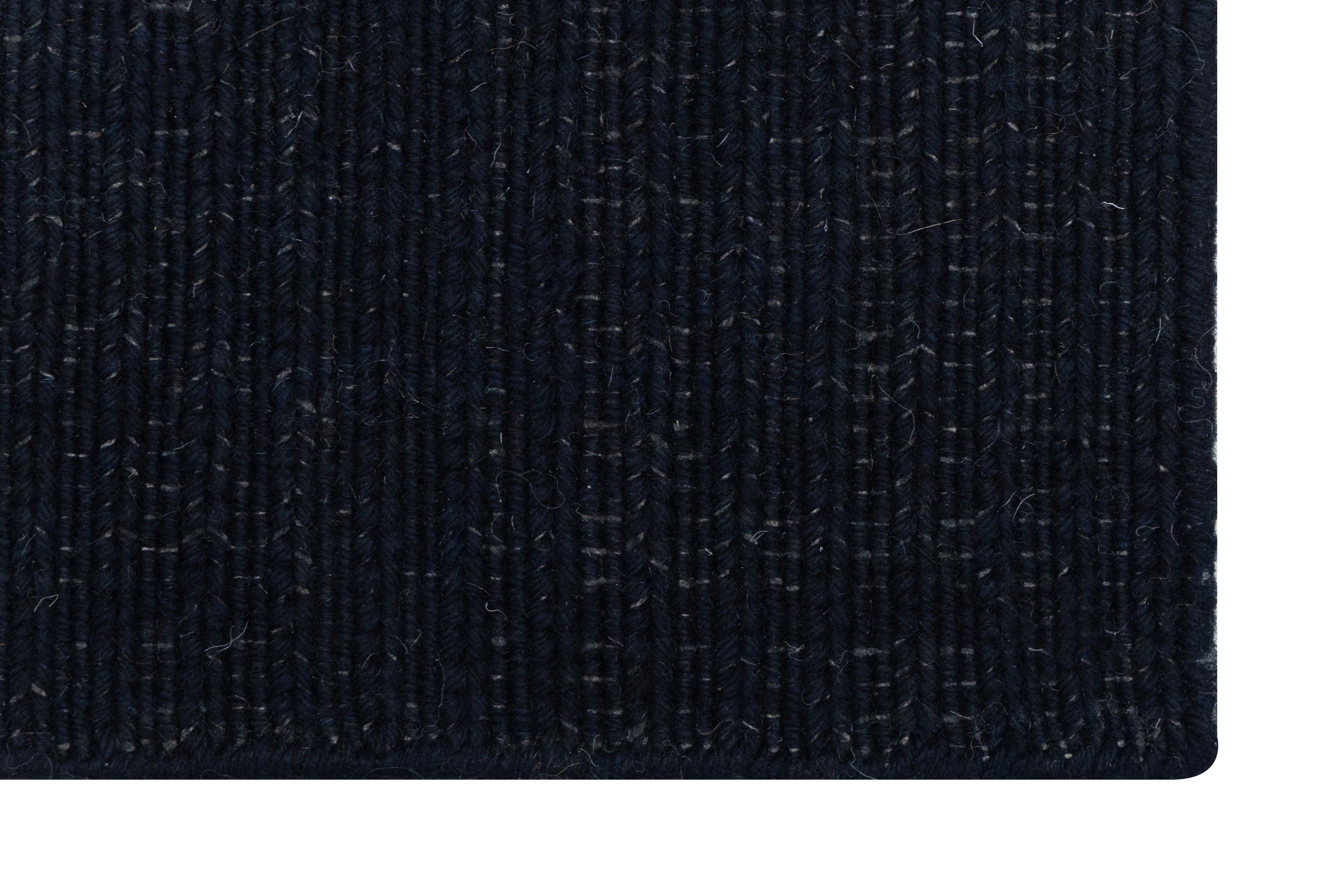 Close-up of Solid Black Texture Hand-Woven Soumak woolen rug for bed rooms, offices, and dining spaces. 