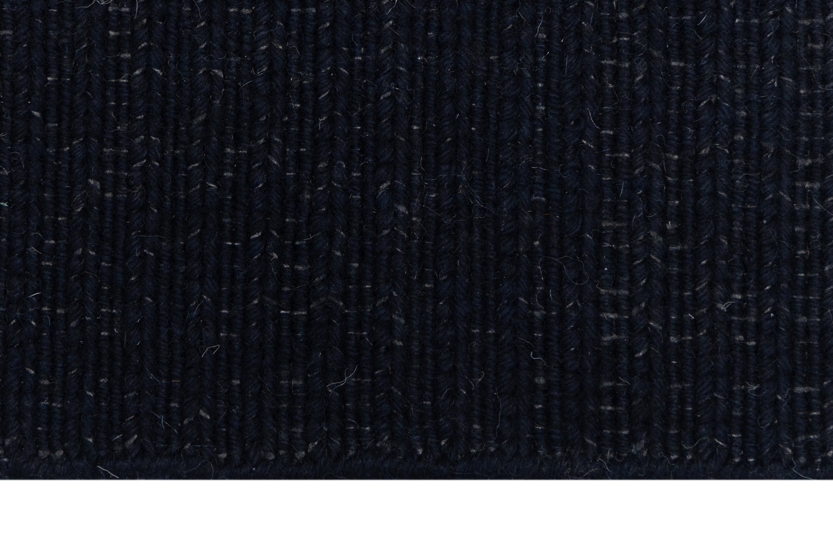Close-up of Solid Black Texture Hand-Woven Soumak woolen rug for bed rooms, offices, and dining spaces. 