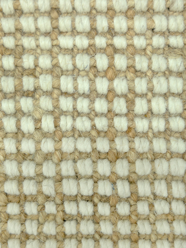 Alpine Grid | Handwoven Pitloom Rug, Close-up of a textured jute and wool beige and cream carpet pattern