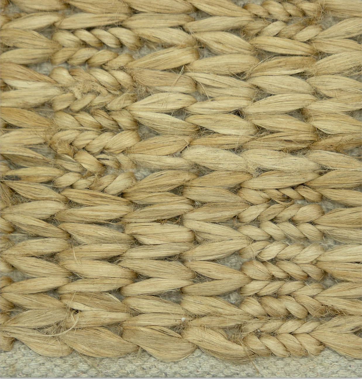 Desert Chevron | Handwoven Pitloom Jute Rug, Close-up of a woven natural fiber jute rug with a textured pattern.