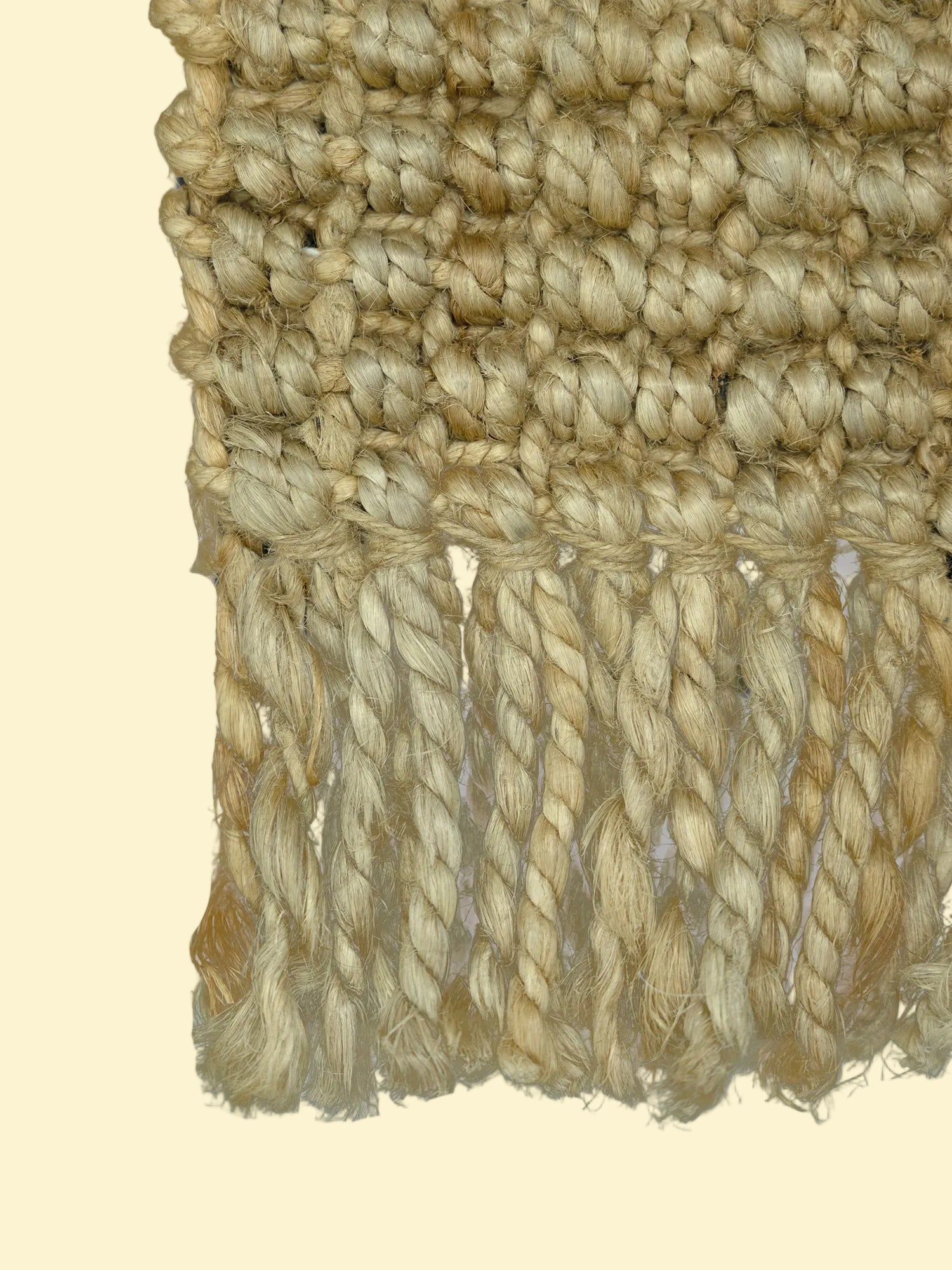 Desert Loom | Handwoven Pitloom Durrie, Close-up of a textured beige jute fabric with braided trim