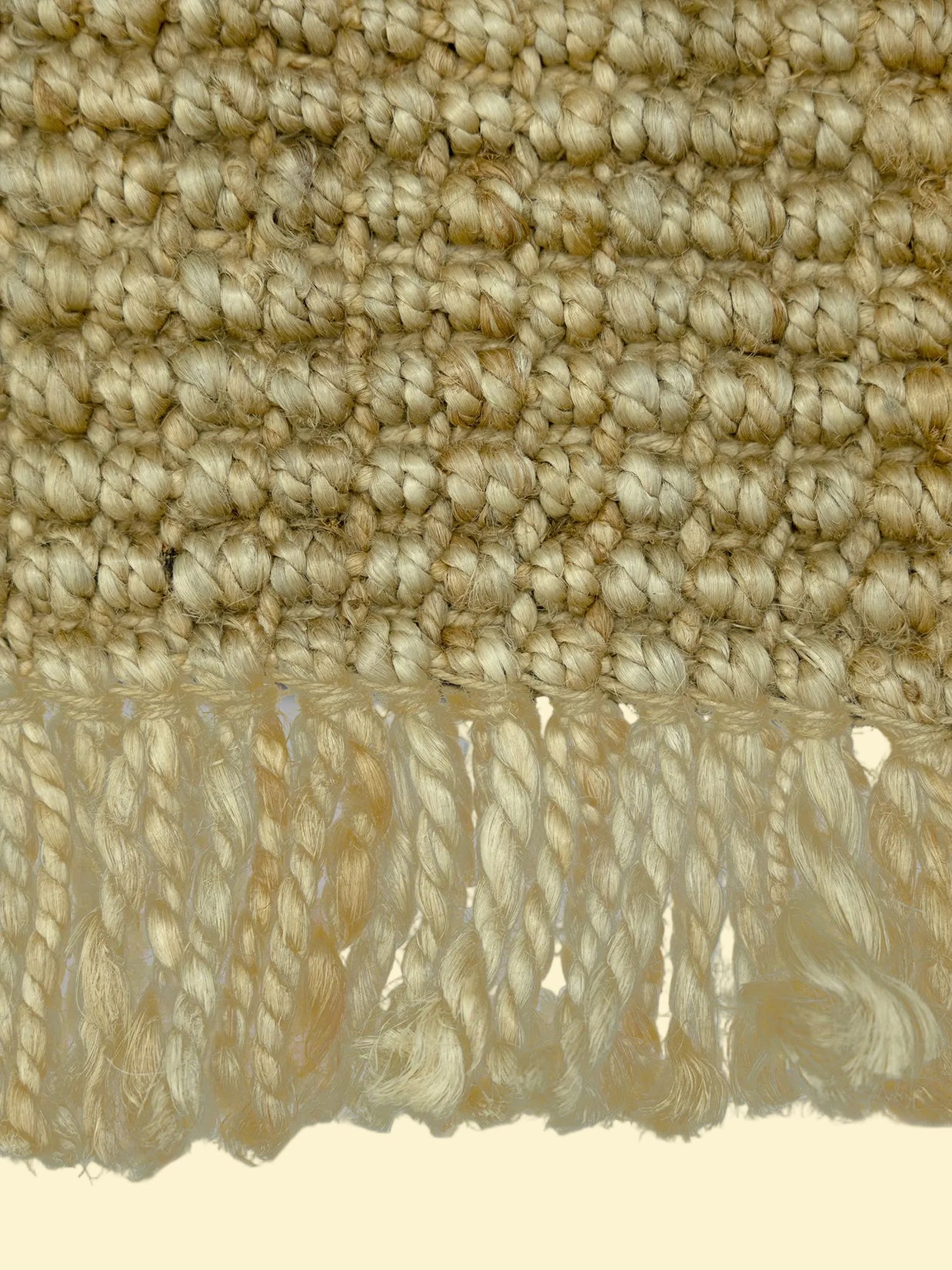 Desert Loom | Handwoven Pitloom Durrie, Close-up of a textured jute rug with fringes