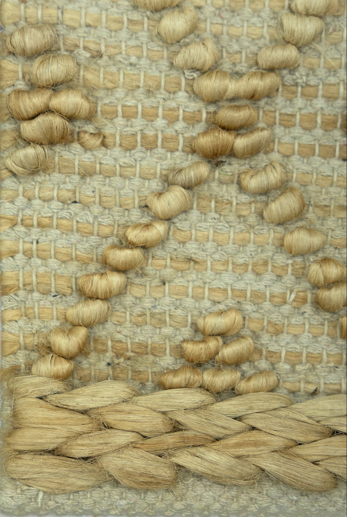 Desert_Mosaic_Handwoven_Pitloom_Jute_Rug_Detail, Close-up of a woven natural jute and wool mat with a geometric pattern.