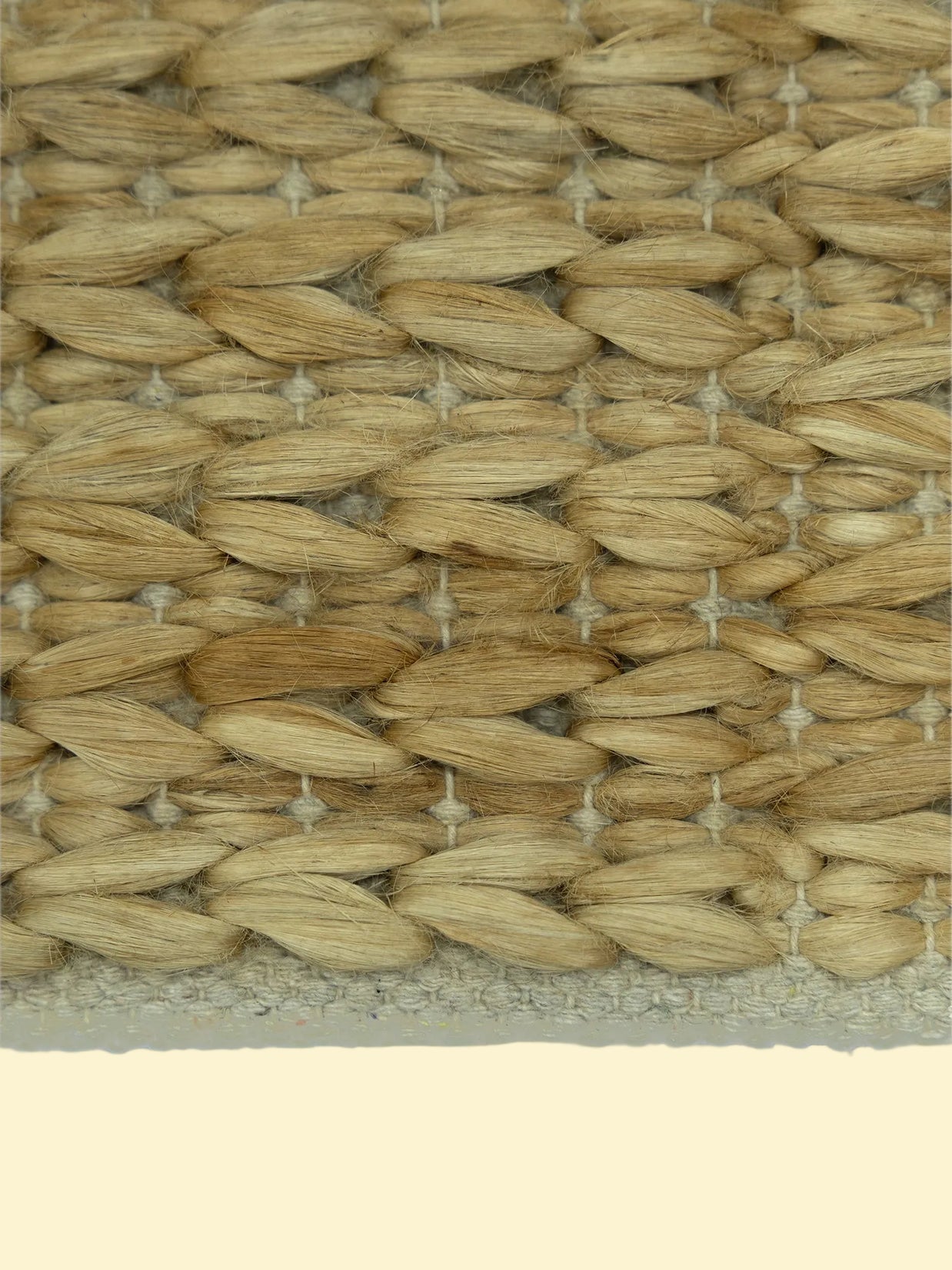 Durry Handwoven Jute Cotton Rug, Close-up of woven straw mat with a natural beige color.