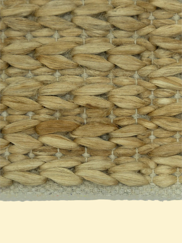 Durry Handwoven Jute Cotton Rug, Close-up of woven straw mat with a natural beige color.