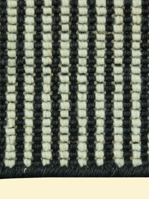 Close-up of a woven pattern of Jute and Wool Rug with black and white stripes.