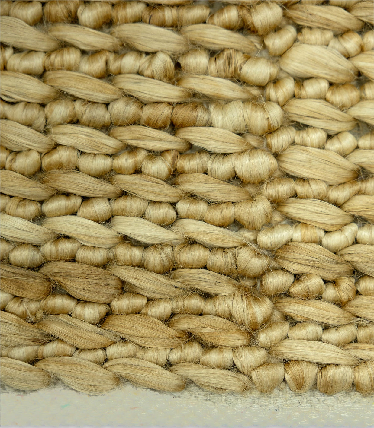Close-up of woven straw matting with a natural beige color.