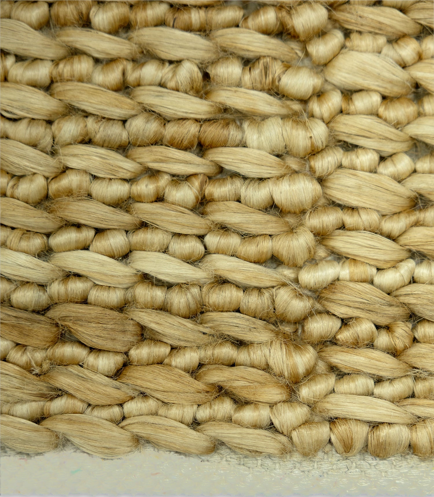 Close-up of woven straw matting with a natural beige color.