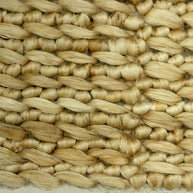 Close-up of woven straw matting with a natural beige color.