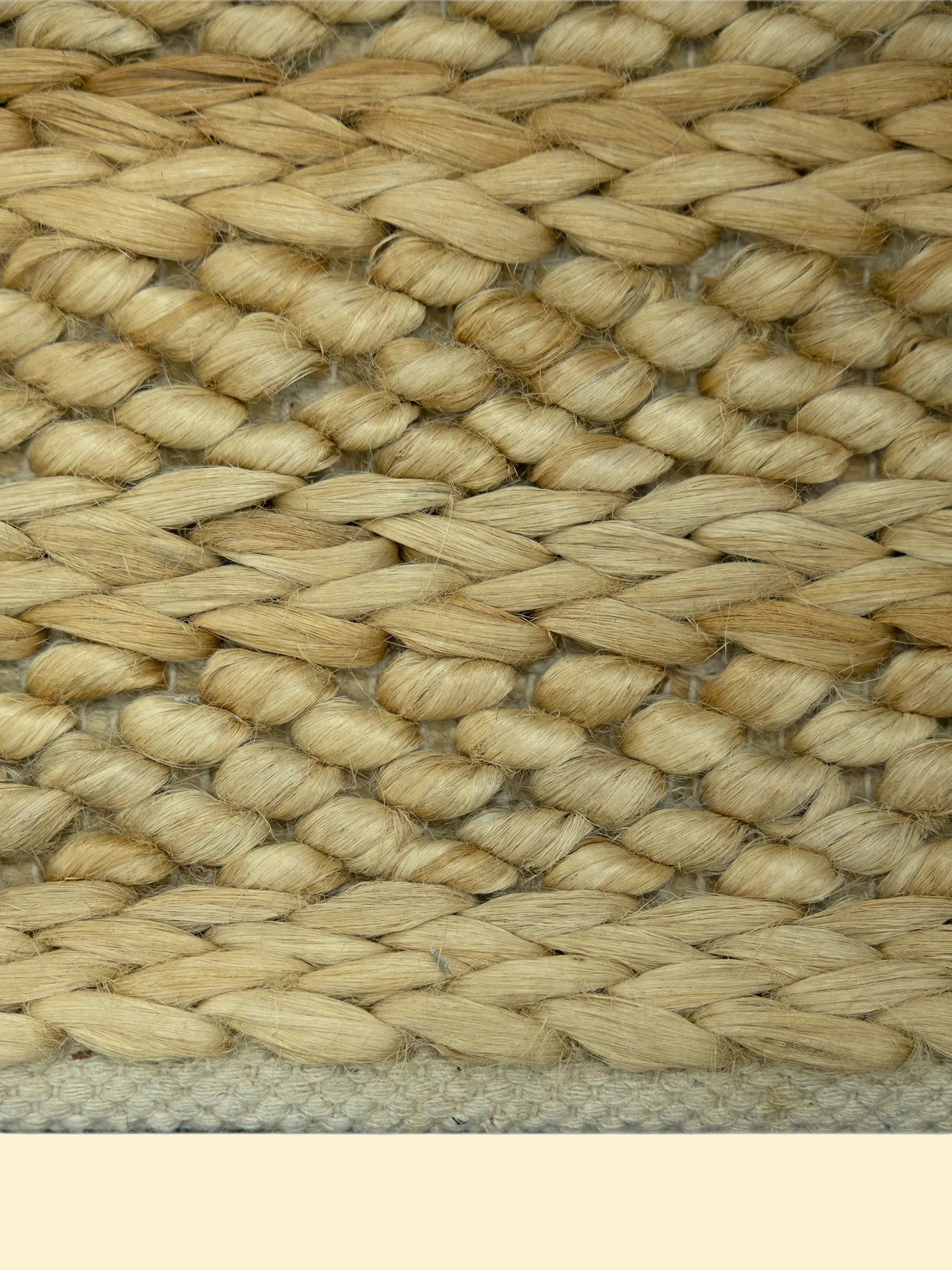Golden Dune | Handwoven Pitloom Jute Rug, Close-up of a woven natural jute bag with a beige color border