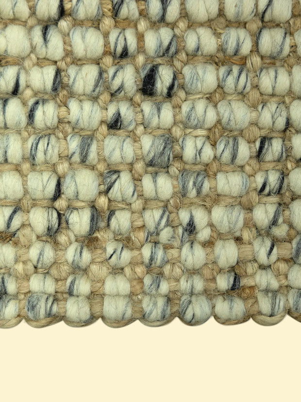 Handmade Durry Pitloom Wool Jute Rug, Close-up of a textured woven jute rug with beige nd black