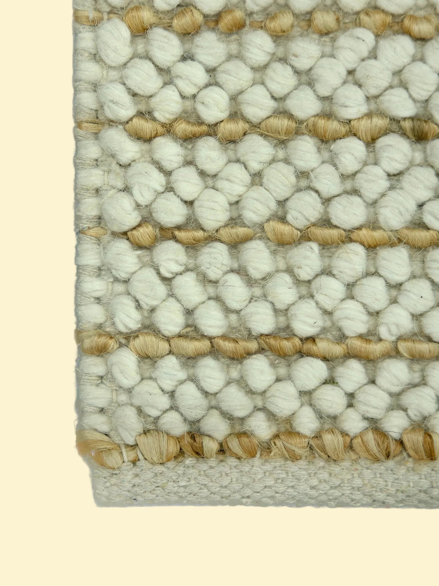 Ivory Pebble | Handwoven Pitloom Durrie, Close-up of a textured jute and wool rug with white and beige pattern
