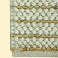 Ivory Pebble | Handwoven Pitloom Durrie, Close-up of a textured jute and wool rug with white and beige pattern