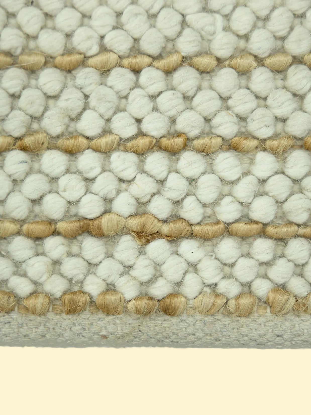 Ivory Pebble | Handwoven Pitloom Durrie, Close-up of a textured jute and wool rug with white and beige pattern