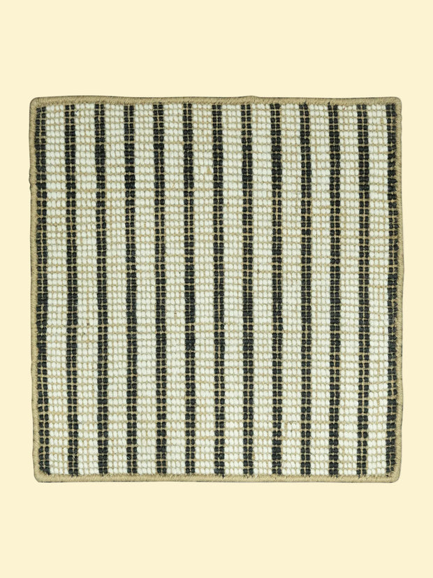 Textured jute and wool rug with black and beige stripes on a white background