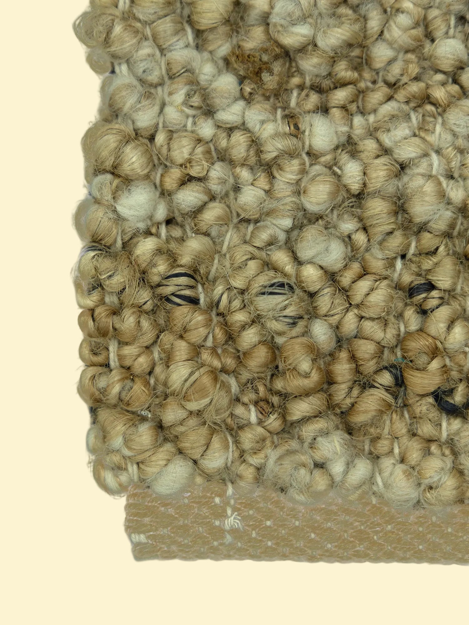 Nomad Texture | Handwoven Pitloom Durrie, Close-up of a textured beige jute carpet corner