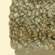 Nomad Texture | Handwoven Pitloom Durrie, Close-up of a textured beige jute carpet corner