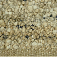 Nomad Texture | Handwoven Pitloom Durrie, Close-up of a textured beige jute carpet