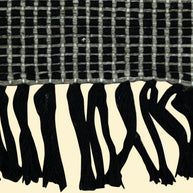 Outdoor_Handwoven_Pitloom_Durrie_Corner, Textured black and white fabric with a checkered pattern above and zebra print below.