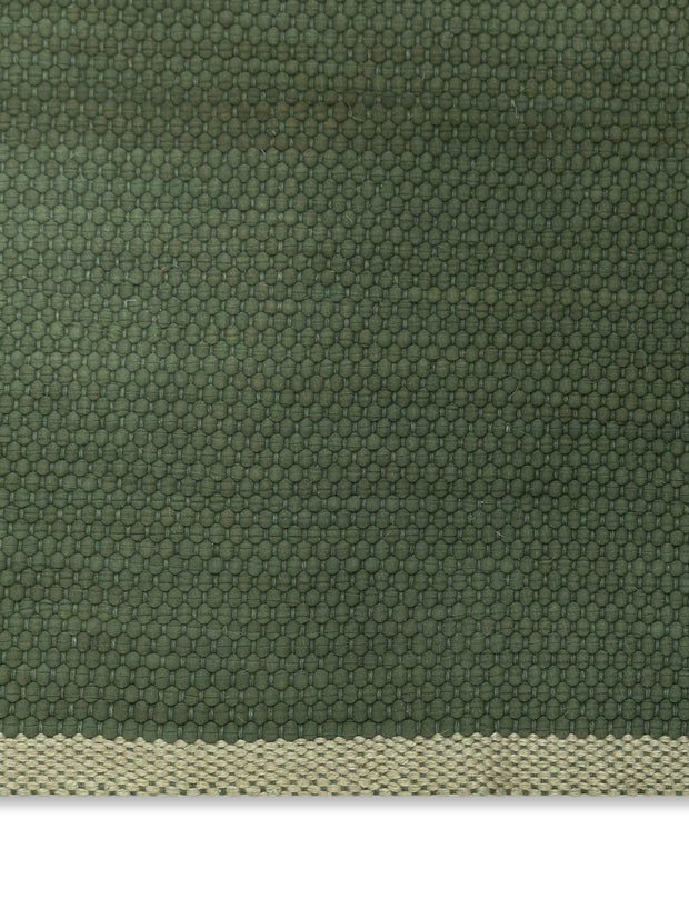 Green wool fabric texture with a subtle pattern and beige border