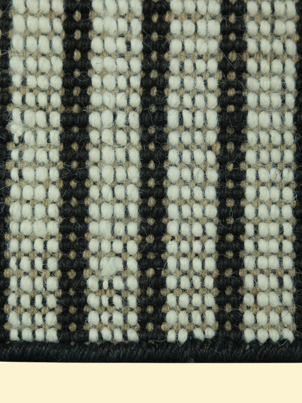Pitloom Handwoven Wool Jute Rug Detail, Close-up of a woven pattern with black, white, and beige colors.