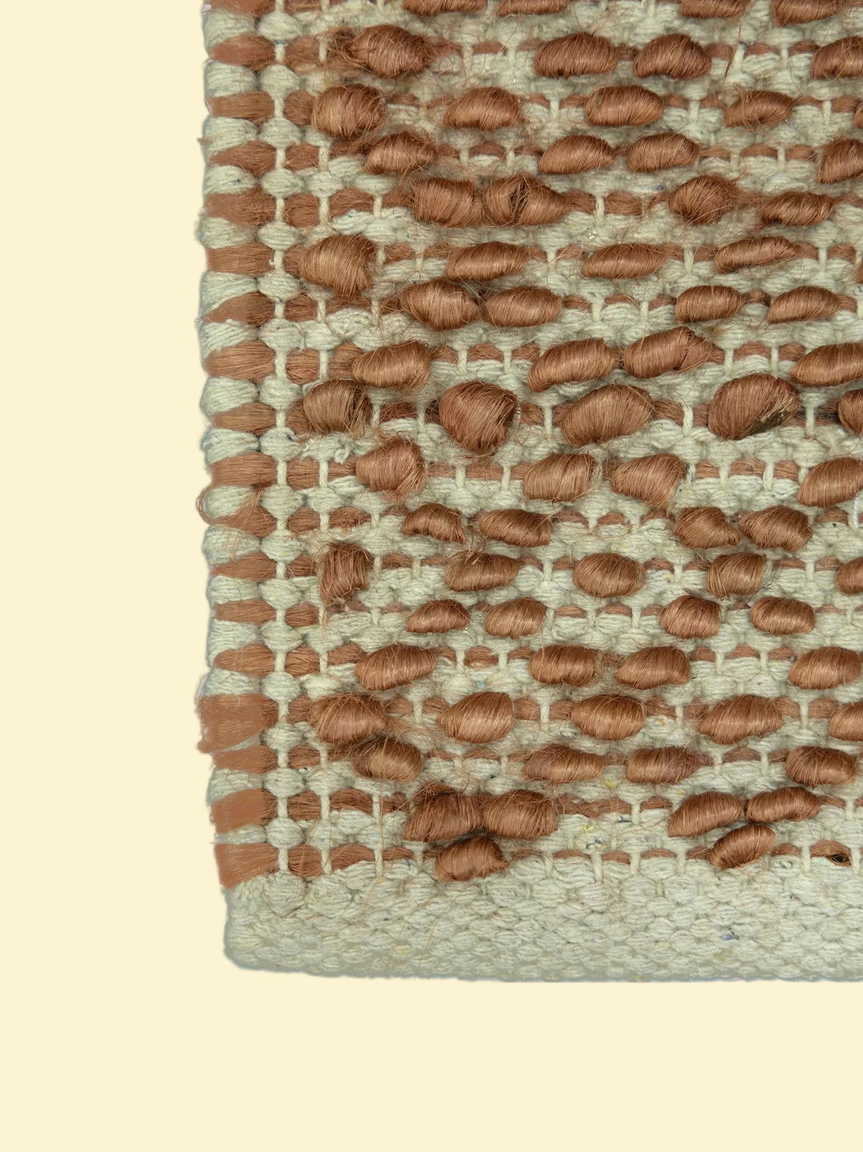 Terracotta Pebble | Handwoven Pitloom Durrie, Close-up of a woven jute and wool rug with brown and beige pattern