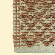 Terracotta Pebble | Handwoven Pitloom Durrie, Close-up of a woven jute and wool rug with brown and beige pattern